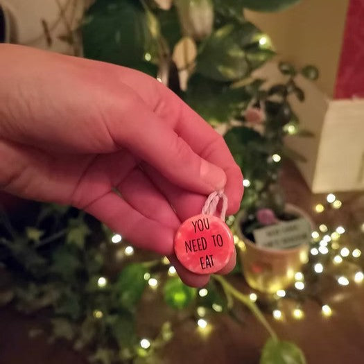 A small tree decorations that read 'you need to eat'