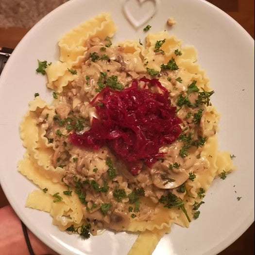 A plate of creamy blue cheese and mushroom pastat with reclaimed red kraut