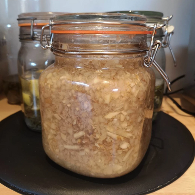 Kilner jar with chopped ginger mixed as a ginger bug