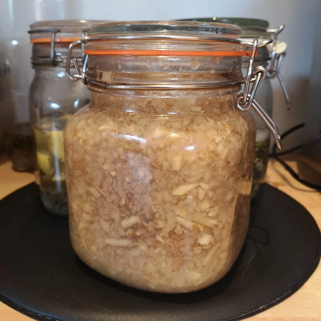Kilner jar with chopped ginger mixed as a ginger bug