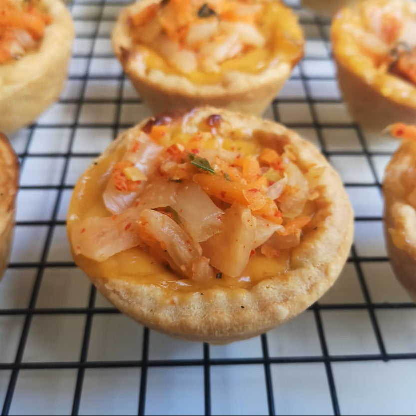 A close up of a vegan cheese and kimchi tart