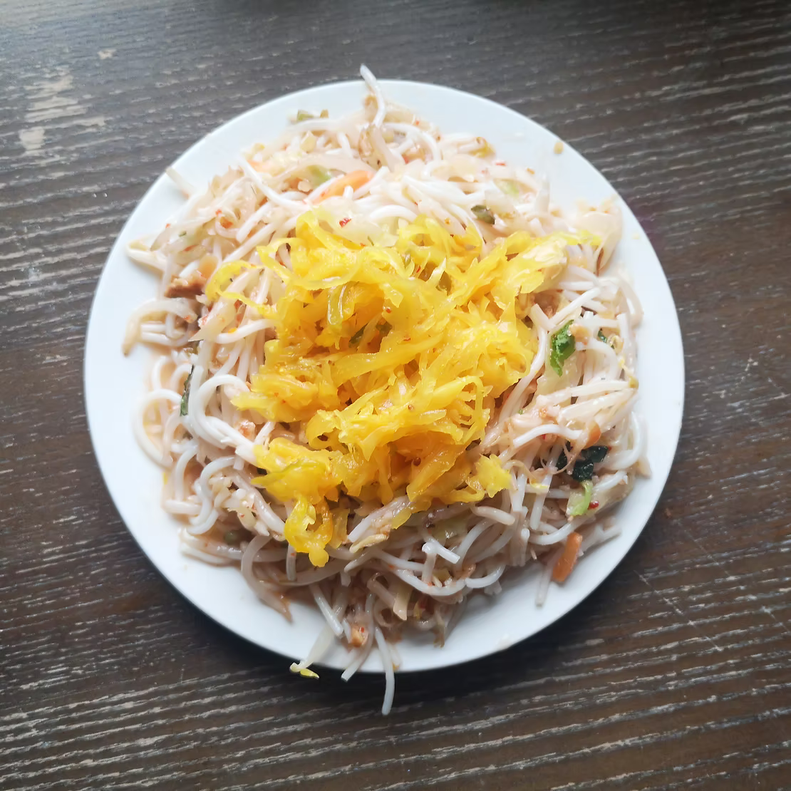 A plate of stir fry noodles topped with crafty pickles piccalilli sauerkraut
