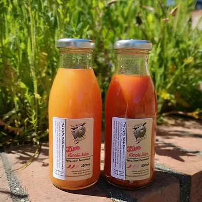 2 bottles of crafty pickles kimchi juice, one mild and one hot