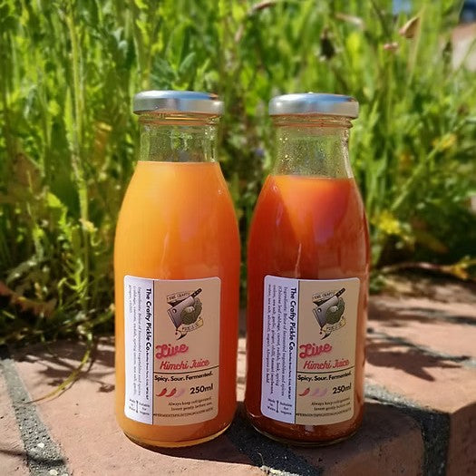 2 bottles of crafty pickles kimchi juice, one mild and one hot