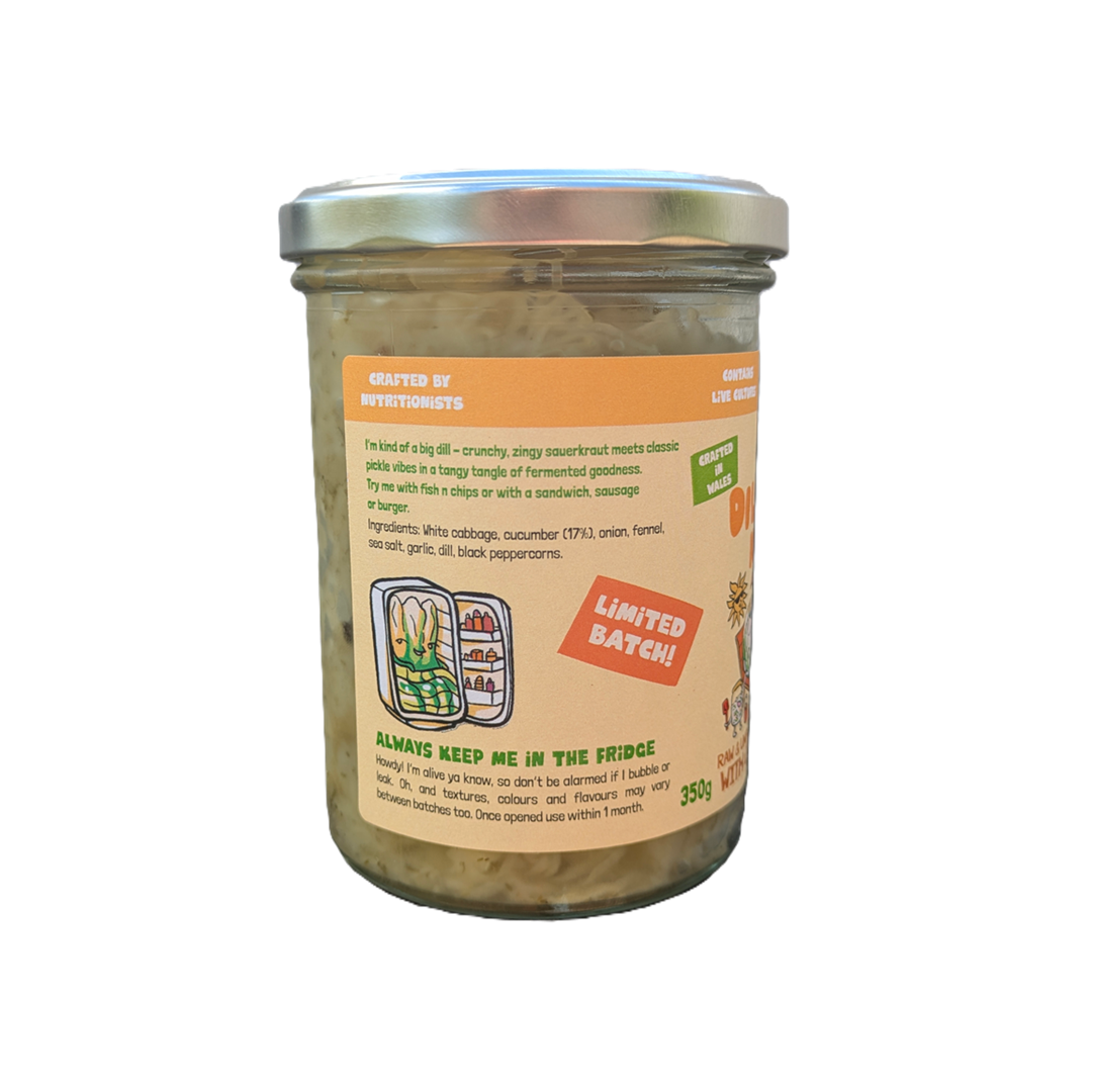 A glass jar of dill pickle kraut turned to the side so ingredients are visible against a white background