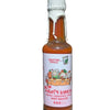 Bottle of fruity kimchi hot sauce in front of purple background